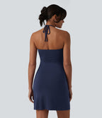Robe resort mini dos nu à col licou avec lien noué dans le dos et poches