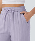Pantalon large fluide taille haute avec cordon de serrage, poches latérales et aspect lin