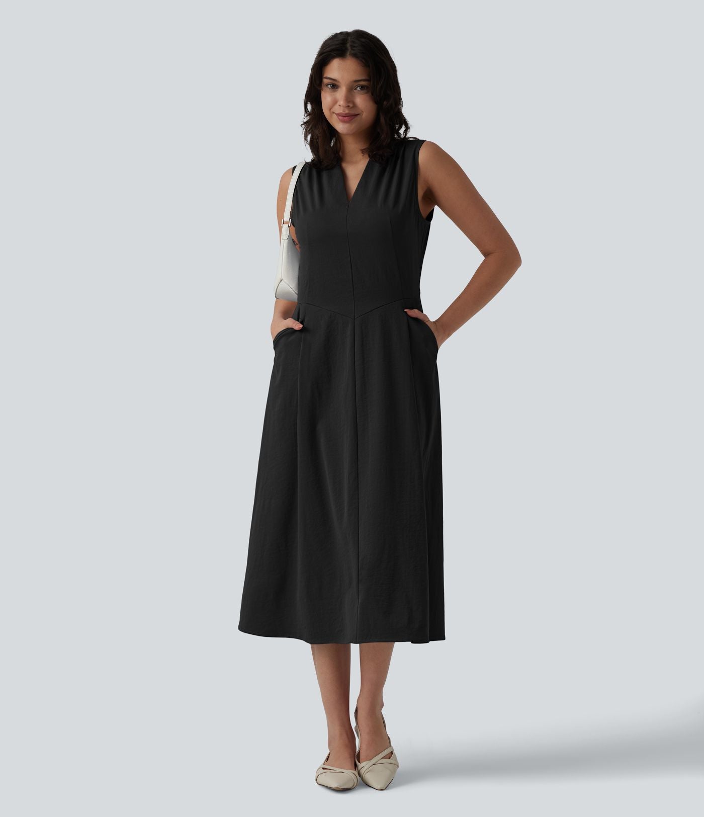 Robe mi-longue plissée col V sans manches avec fermeture éclair invisible et poches pour le travail