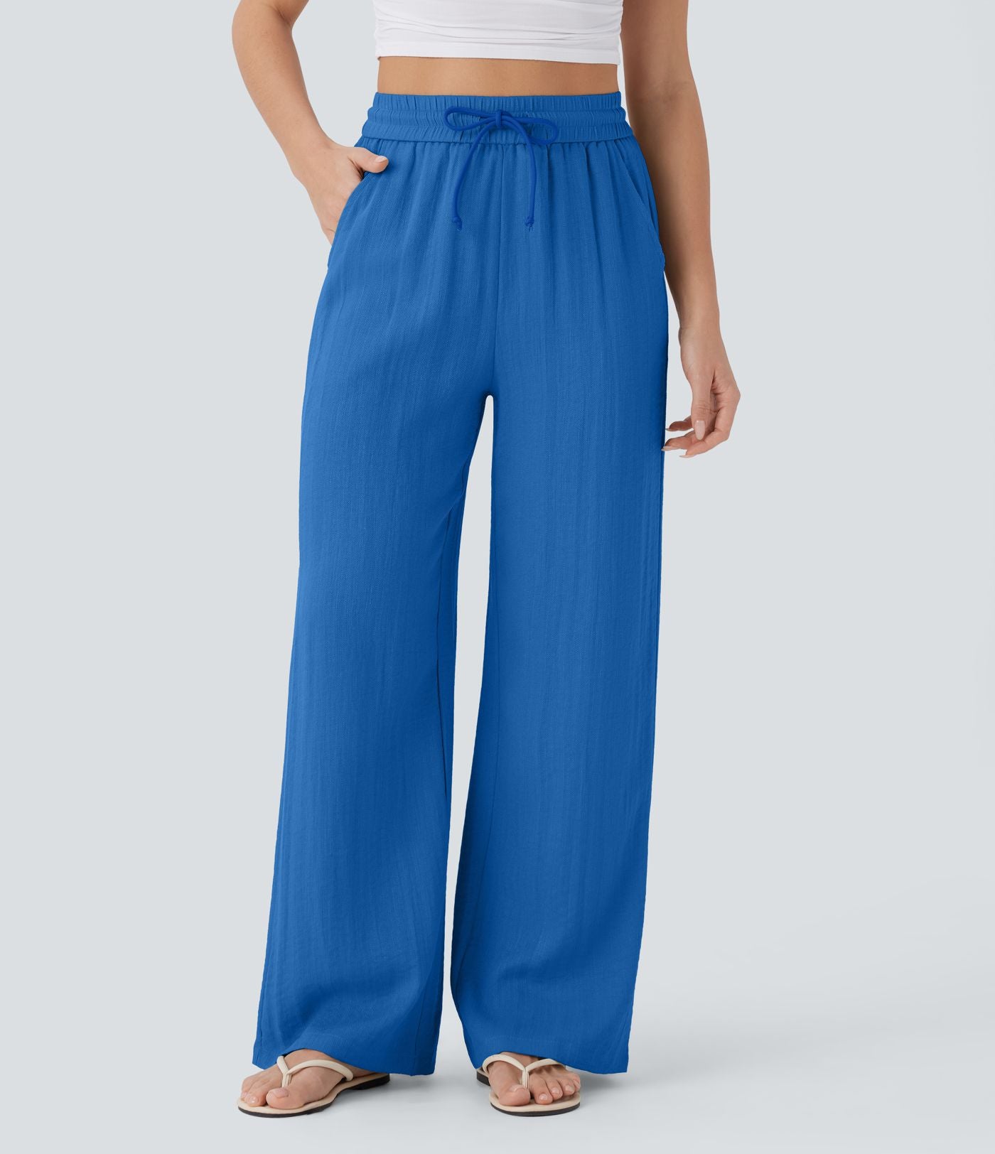 Pantalon large fluide taille haute avec cordon de serrage, poches latérales et aspect lin