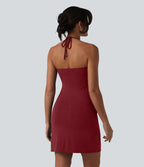 Robe resort mini dos nu à col licou avec lien noué dans le dos et poches