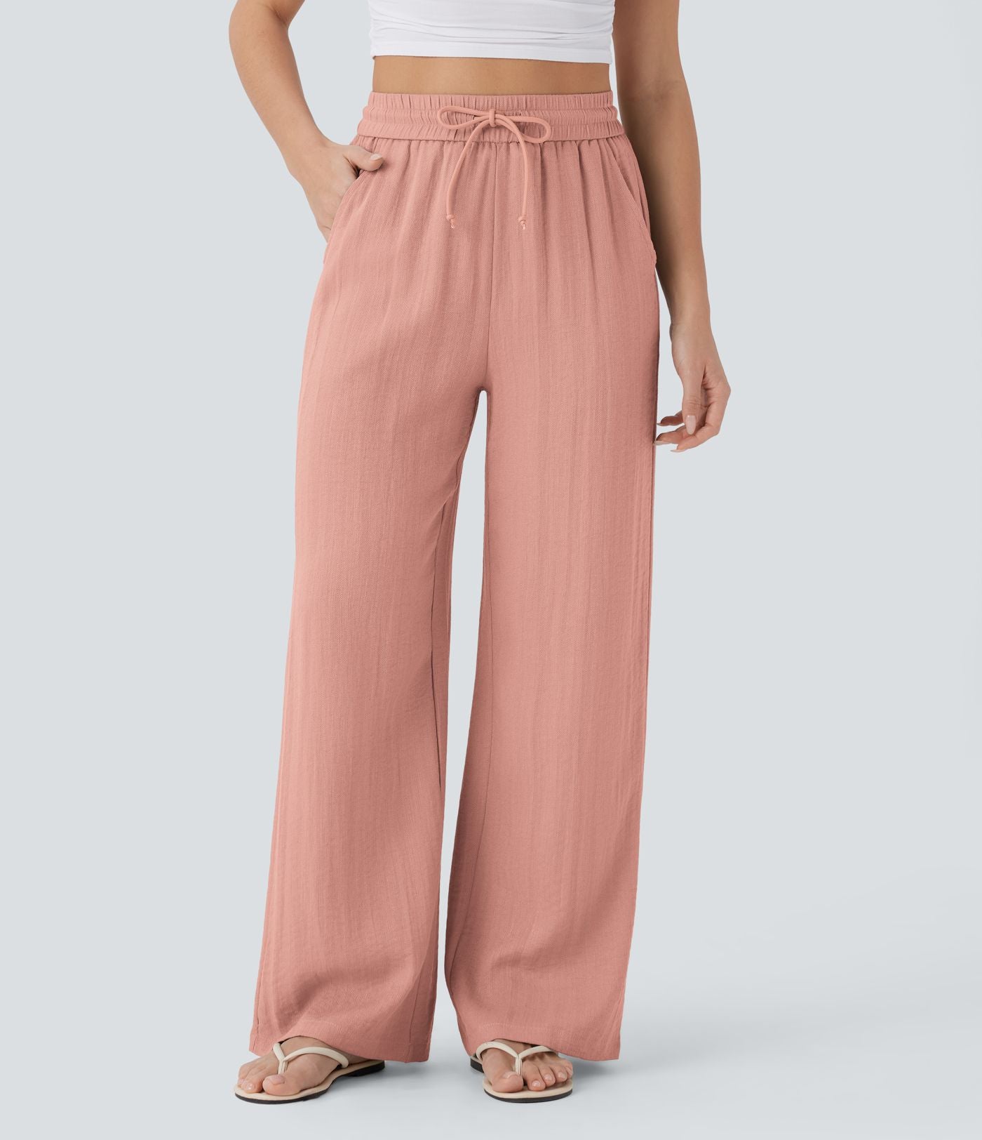 Pantalon large fluide taille haute avec cordon de serrage, poches latérales et aspect lin