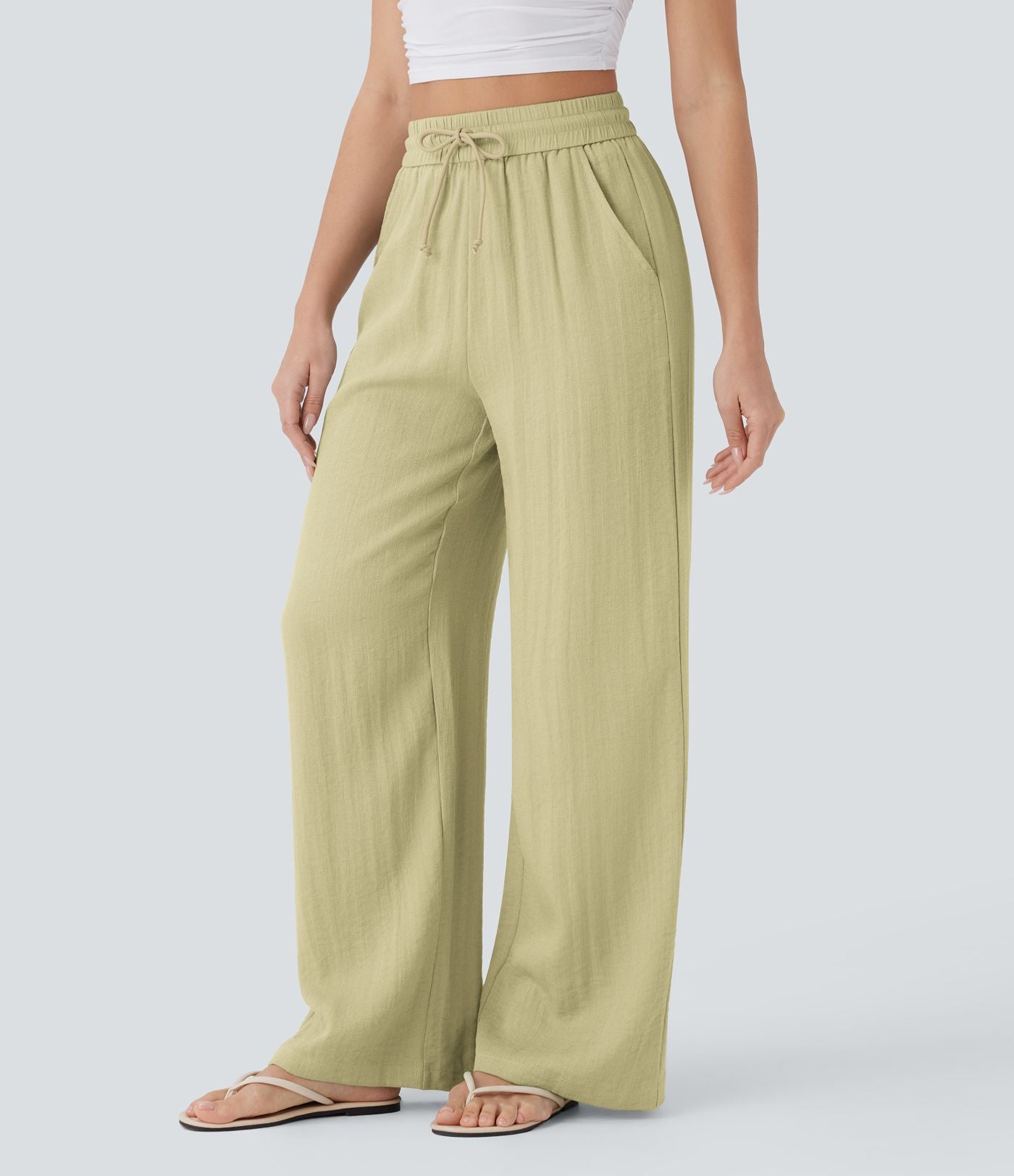 Pantalon large fluide taille haute avec cordon de serrage, poches latérales et aspect lin