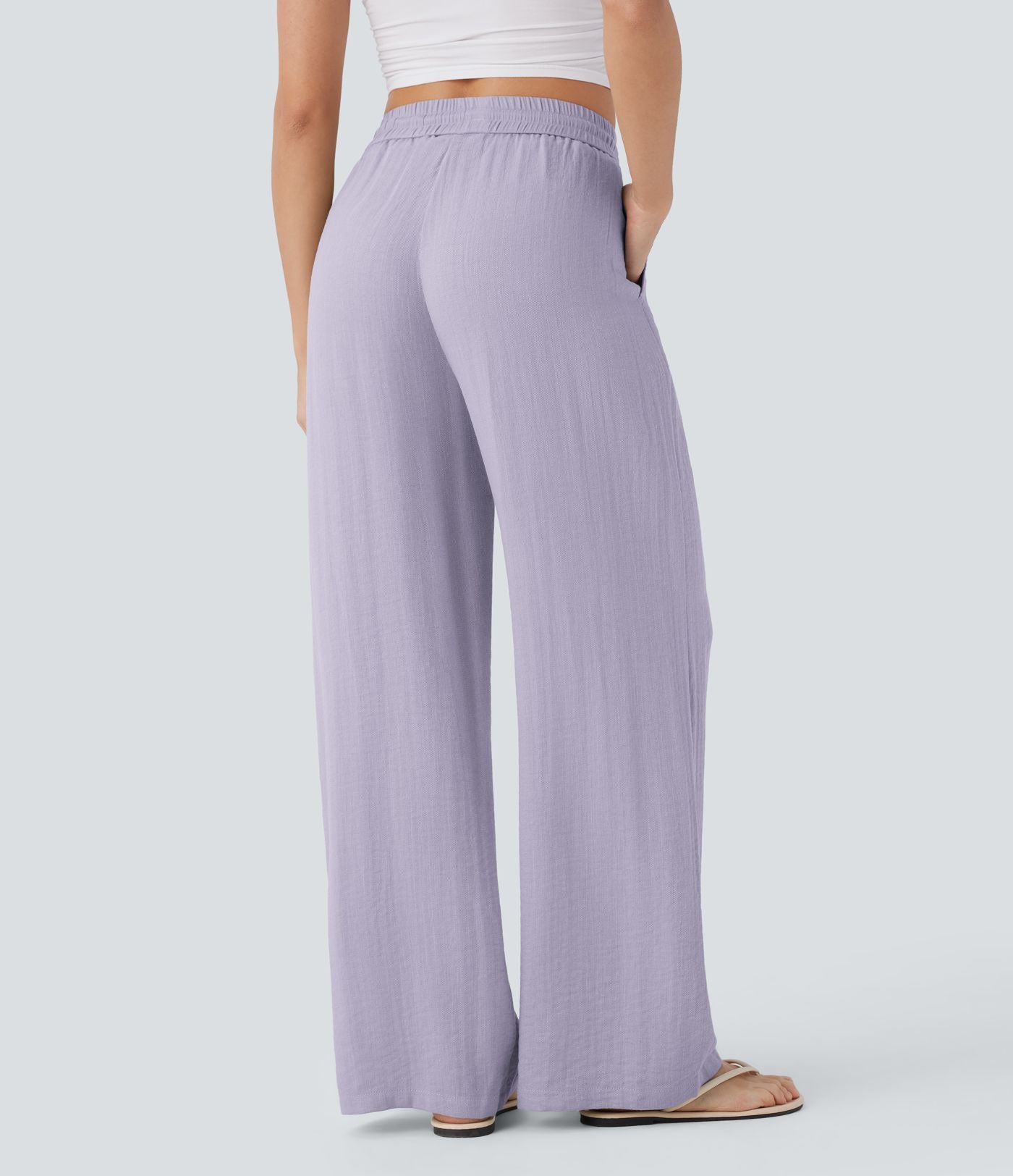Pantalon large fluide taille haute avec cordon de serrage, poches latérales et aspect lin