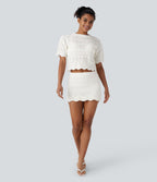 Jupe-short courte en maille ajourée taille haute avec poches latérales