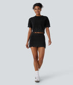 Jupe-short courte en maille ajourée taille haute avec poches latérales