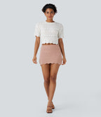 Jupe-short courte en maille ajourée taille haute avec poches latérales