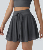 Jupe mini fluide évasée 2-en-1 taille haute à cordon, empiècements en mesh contrastant, avec poche, version plus longue