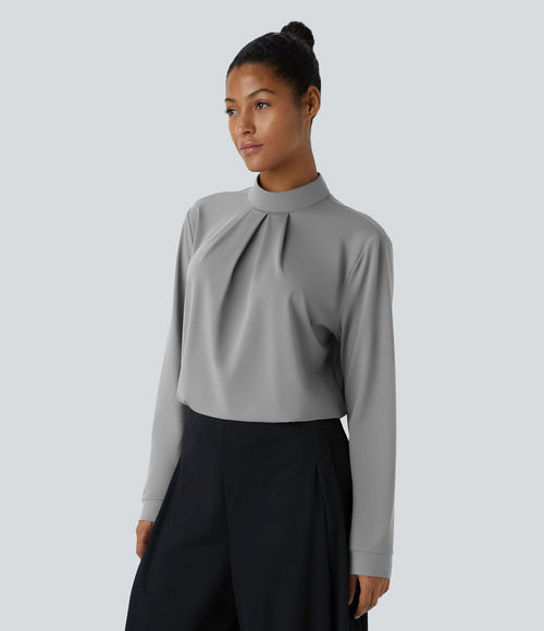 Blouse de travail à col montant, plis, boutons au dos et manches longues