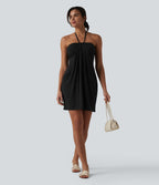 Robe resort mini dos nu à col licou avec lien noué dans le dos et poches