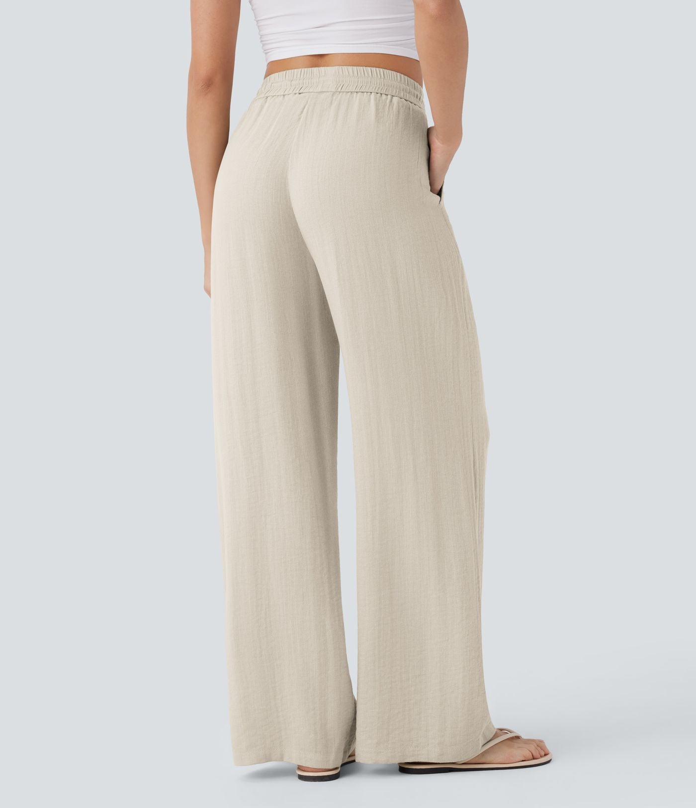 Pantalon large fluide taille haute avec cordon de serrage, poches latérales et aspect lin