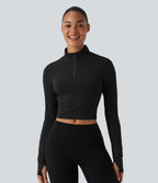 Haut de sport court col cheminée demi-zip manches longues avec passe-pouces