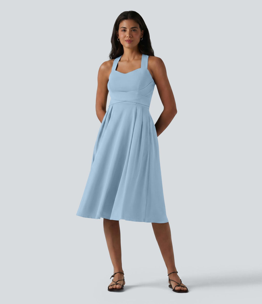 Robe midi fluide sans manches décolleté cœur avec bretelles croisées, nœud dans le dos et poches