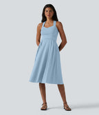 Robe midi fluide sans manches décolleté cœur avec bretelles croisées, nœud dans le dos et poches