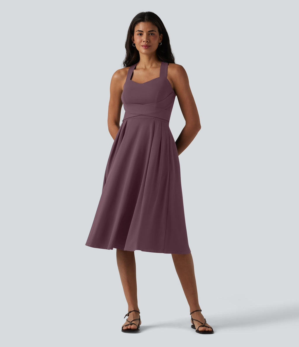 Robe midi fluide sans manches décolleté cœur avec bretelles croisées, nœud dans le dos et poches