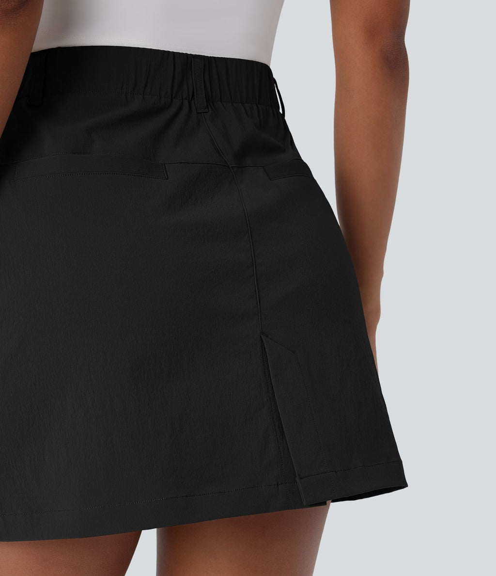 Jupe courte de golf ligne A taille haute avec boutons, zip, poches latérales et fente
