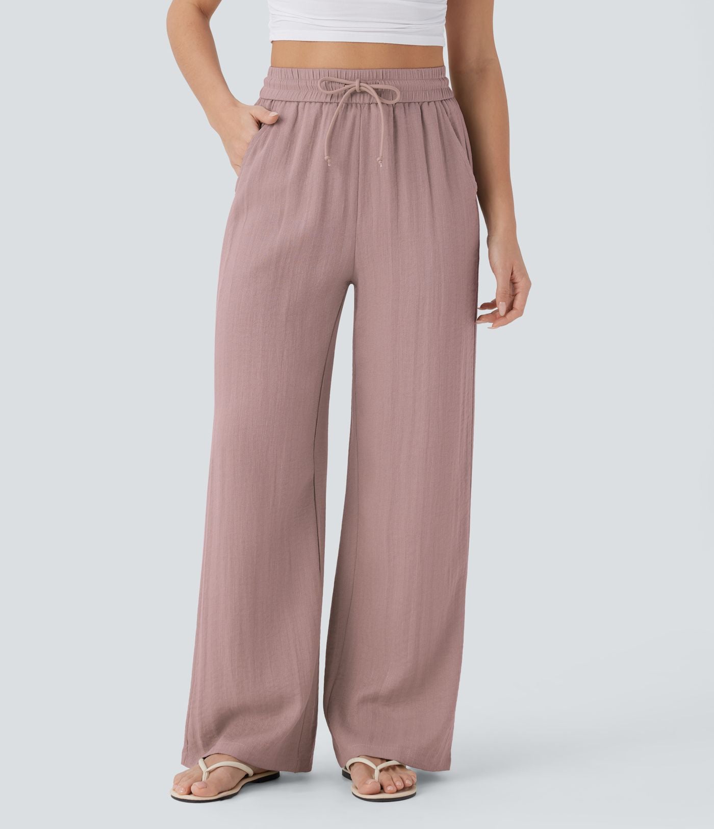 Pantalon large fluide taille haute avec cordon de serrage, poches latérales et aspect lin