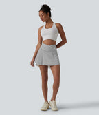 Jupe de tennis mini 2 en 1 à rayures, taille haute croisée, ourlet arrondi et poches