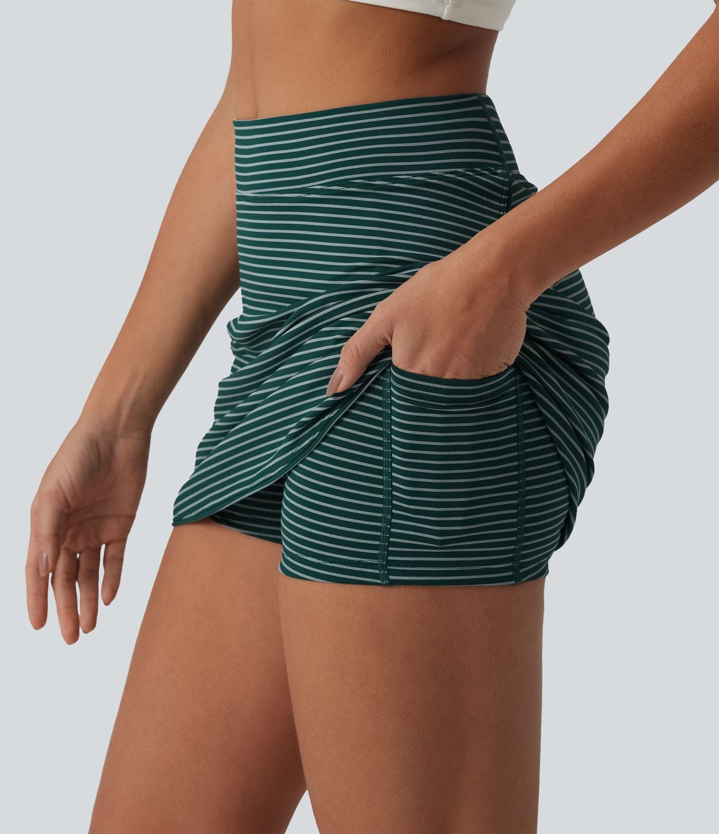 Jupe de golf mini moulante 2-en-1 taille haute à rayures avec poches
