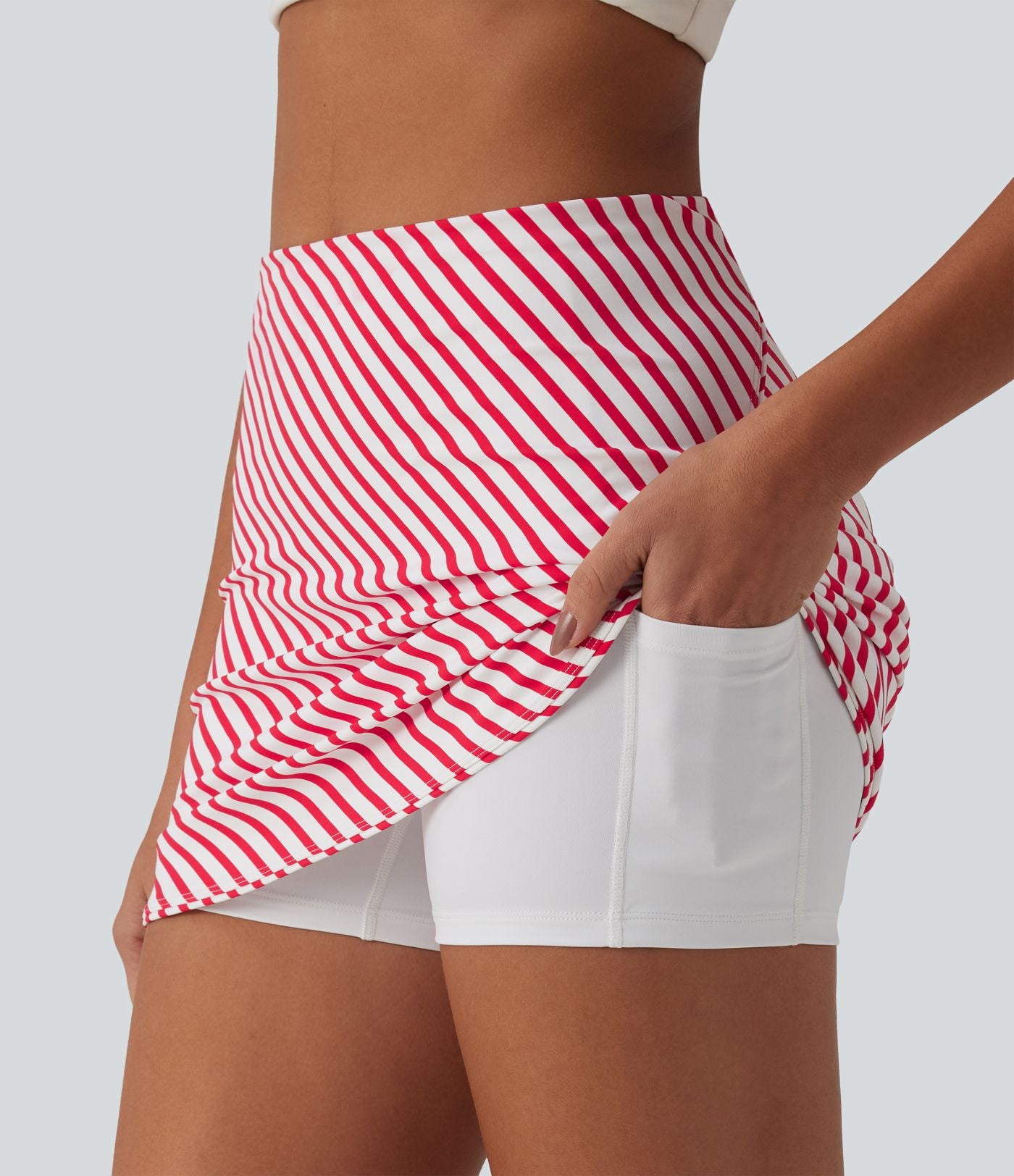 Jupe mini de tennis 2-en-1 à rayures taille haute avec ourlet arrondi et poches