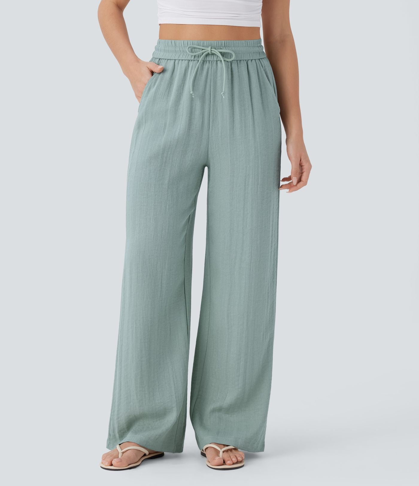 Pantalon large fluide taille haute avec cordon de serrage, poches latérales et aspect lin