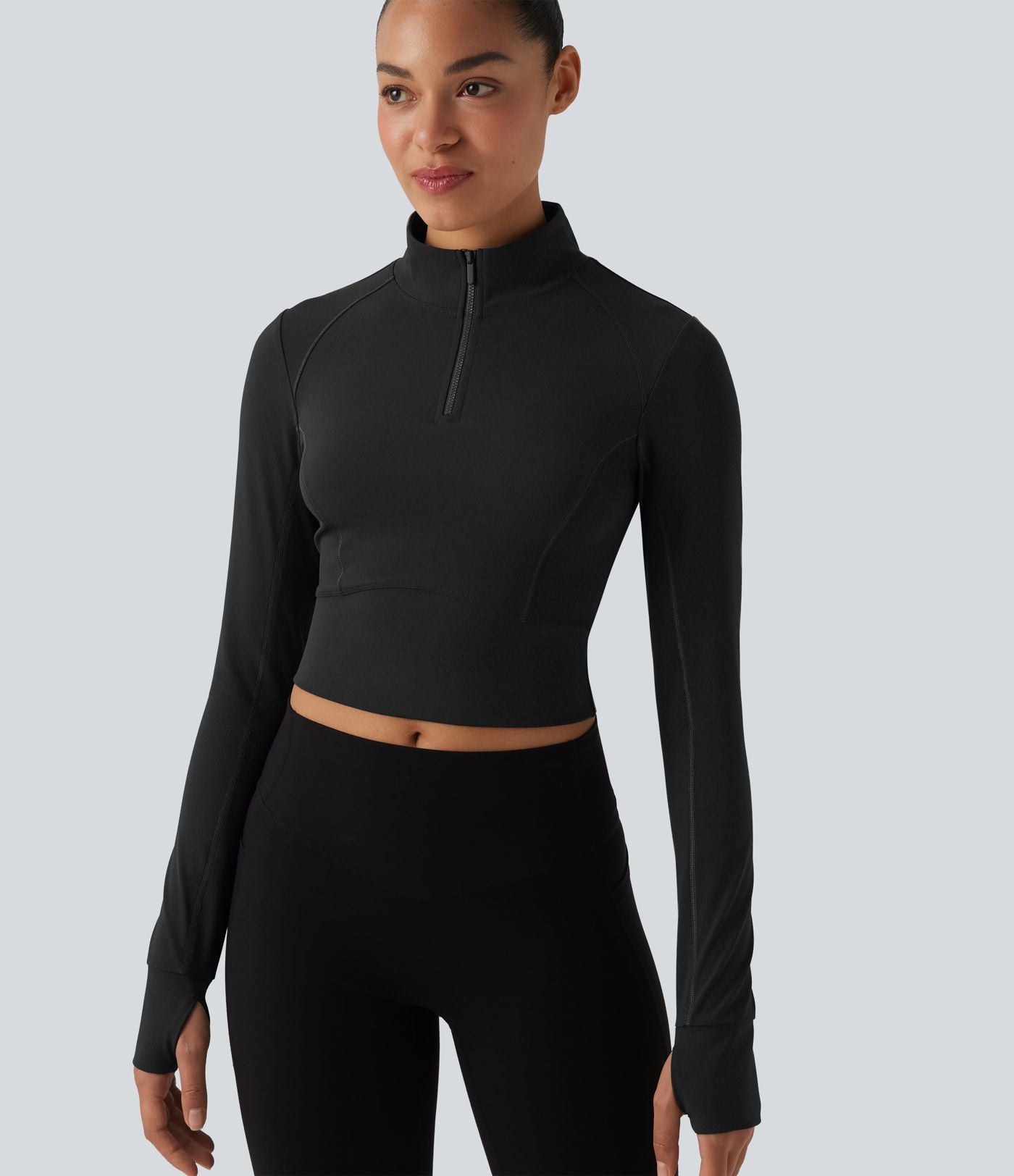Haut de sport court col cheminée demi-zip manches longues avec passe-pouces