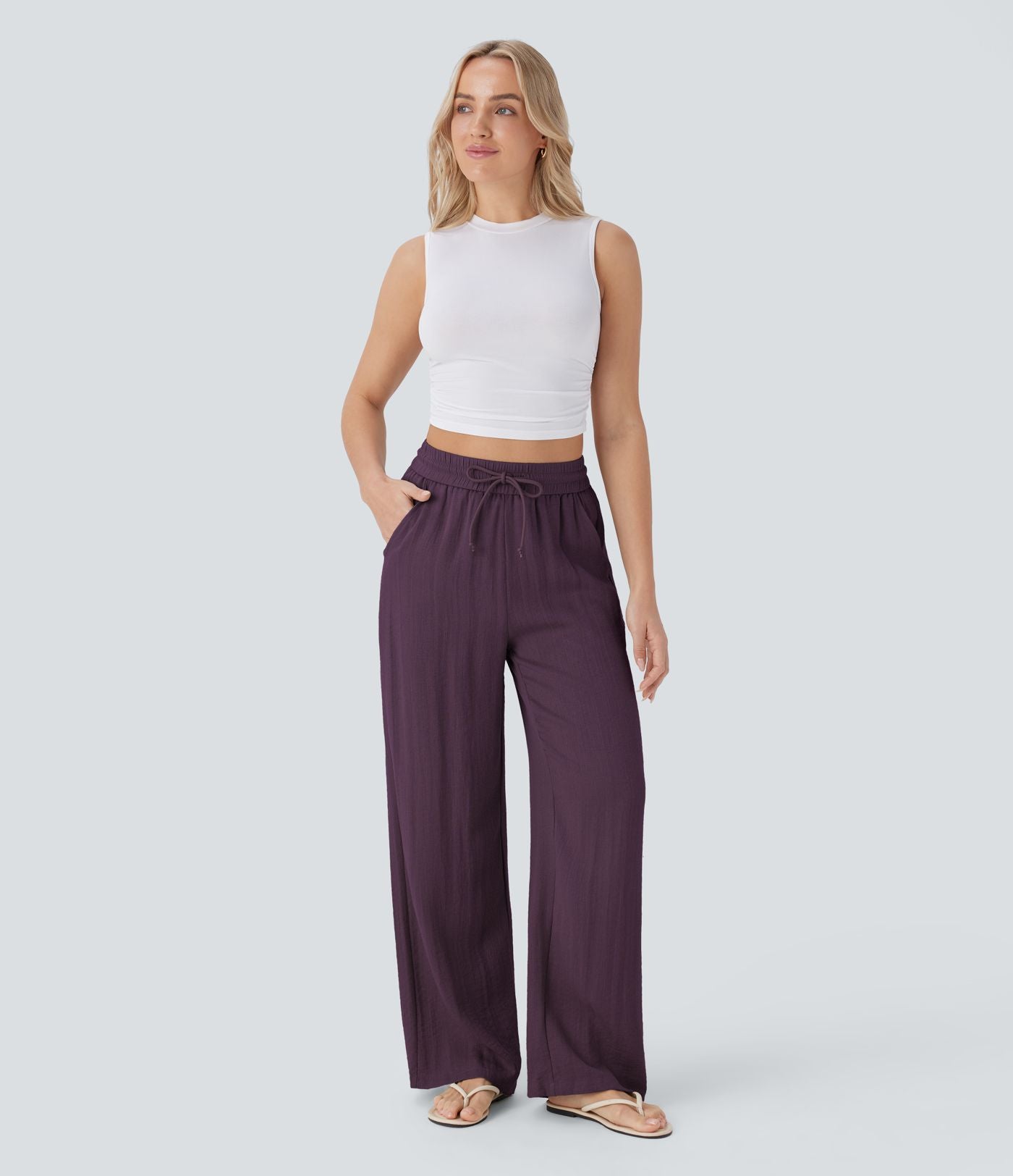 Pantalon large fluide taille haute avec cordon de serrage, poches latérales et aspect lin