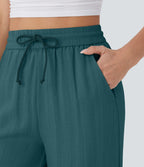 Pantalon large fluide taille haute avec cordon de serrage, poches latérales et aspect lin