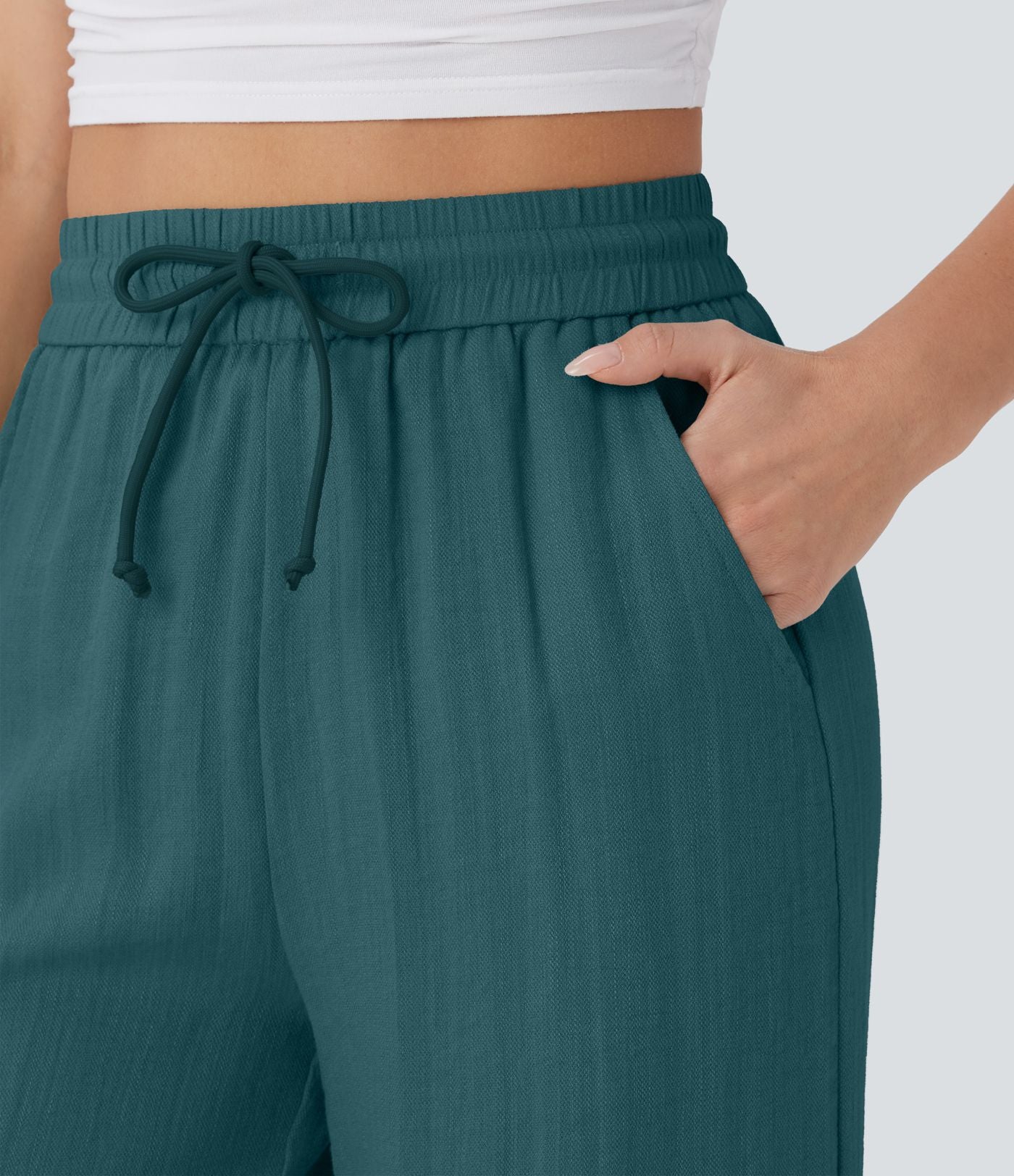 Pantalon large fluide taille haute avec cordon de serrage, poches latérales et aspect lin