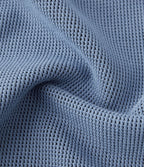 Jean décontracté taille basse en maille gaufrée extensible, jambe large avec poches multiples et fermeture zippée