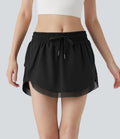 Mini-jupe de tennis 2-en-1 taille moyenne avec cordon de serrage, filet contrasté et poches latérales