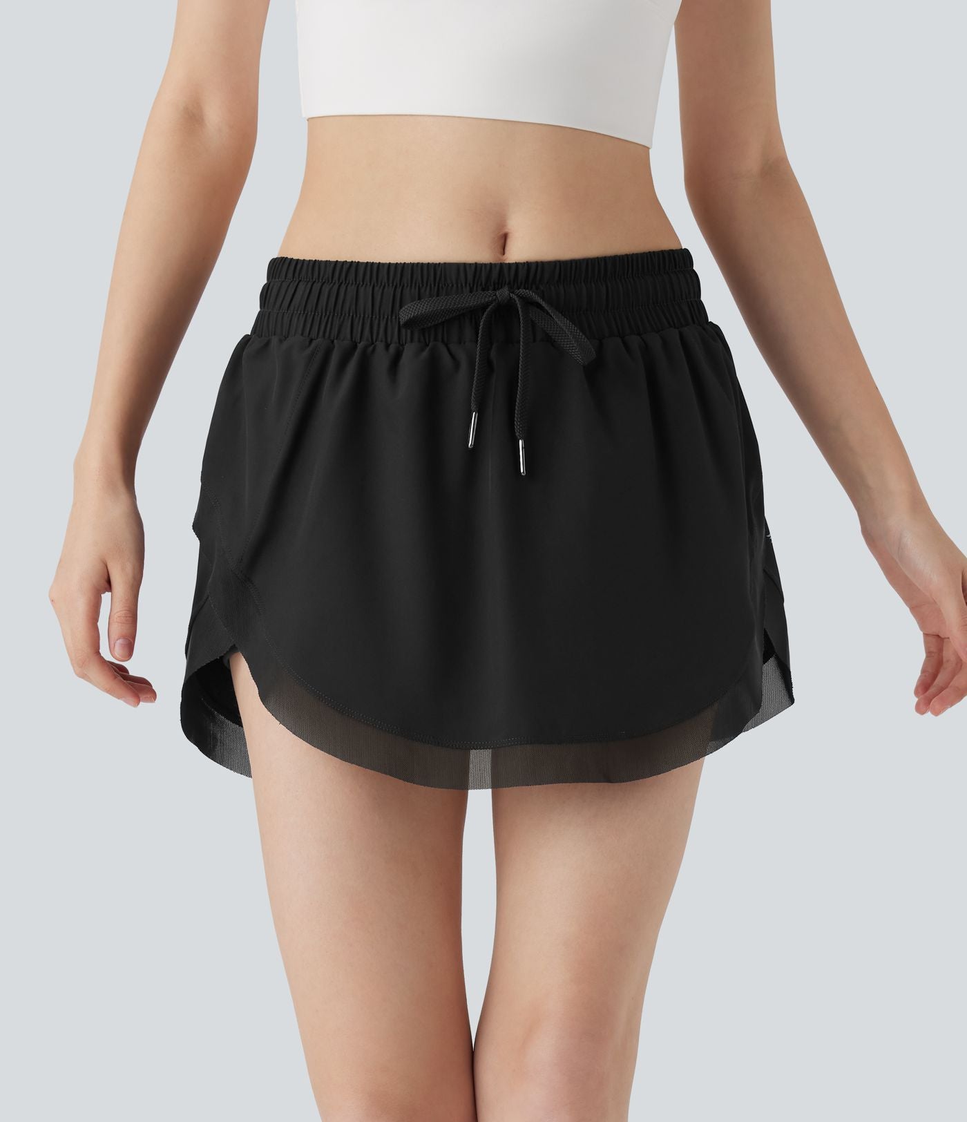 Mini-jupe de tennis 2-en-1 taille moyenne avec cordon de serrage, filet contrasté et poches latérales