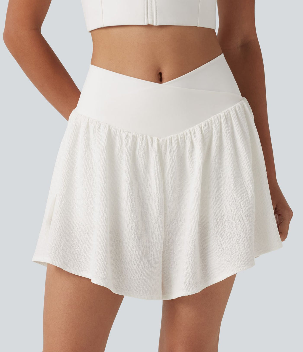 Short de running 2-en-1 taille haute croisée en tissu froissé avec ourlet fendu et poches