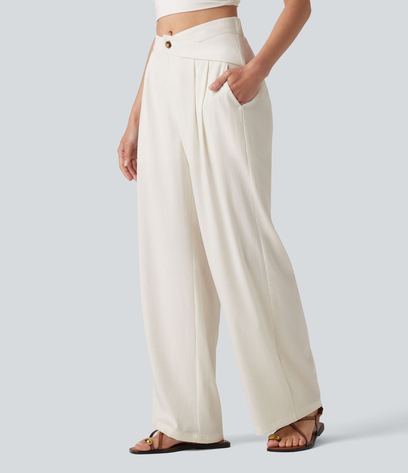 Pantalon large fluide asymétrique taille mi-haute plissé avec poches et aspect lin