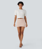 Jupe-short courte en maille ajourée taille haute avec poches latérales