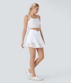 Jupe courte de yoga évasée 2-en-1 taille haute croisée avec poches latérales et motif perforé