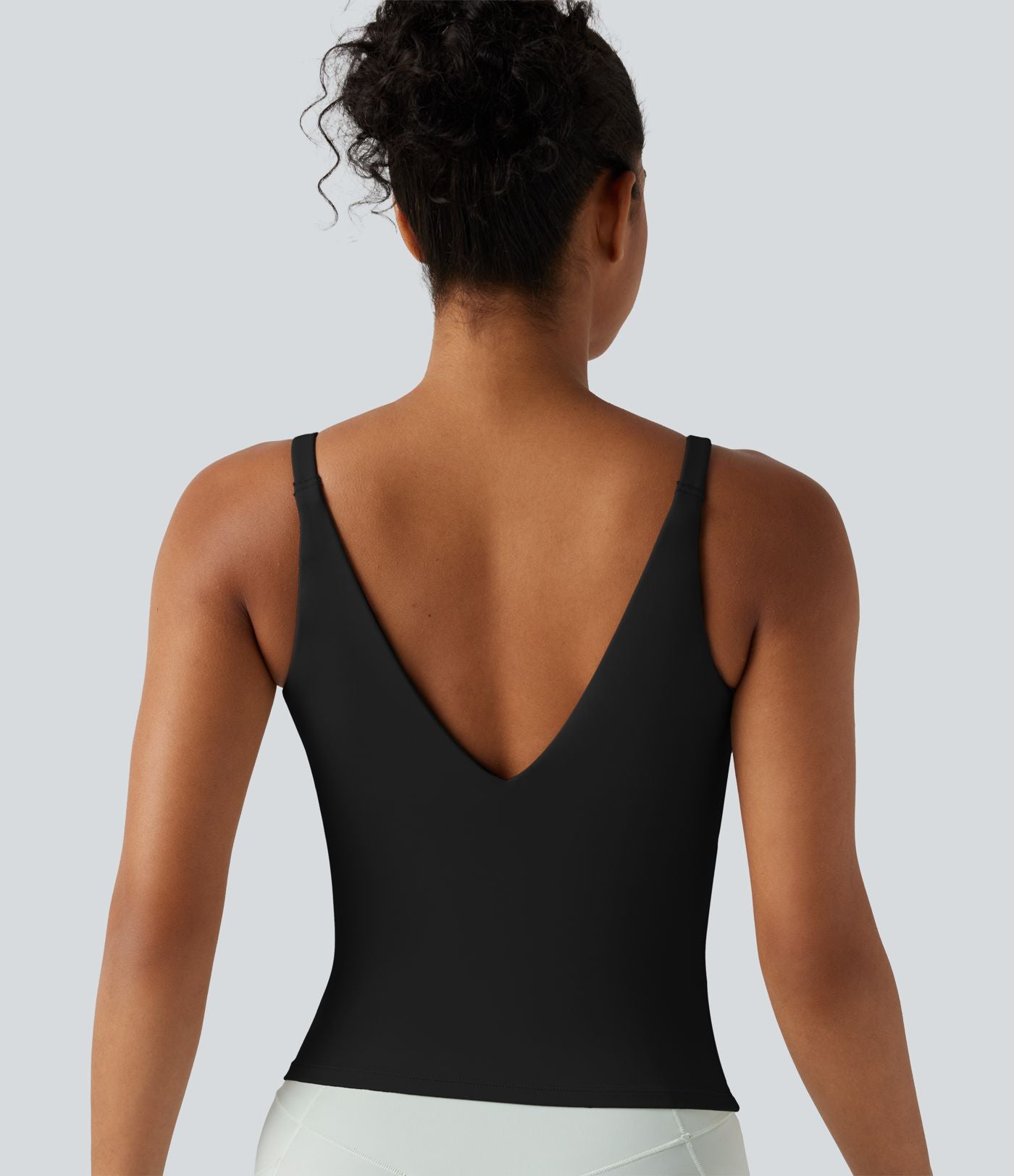 Débardeur de sport effet lissant sous les bras avec dos en V et brassière intégrée
