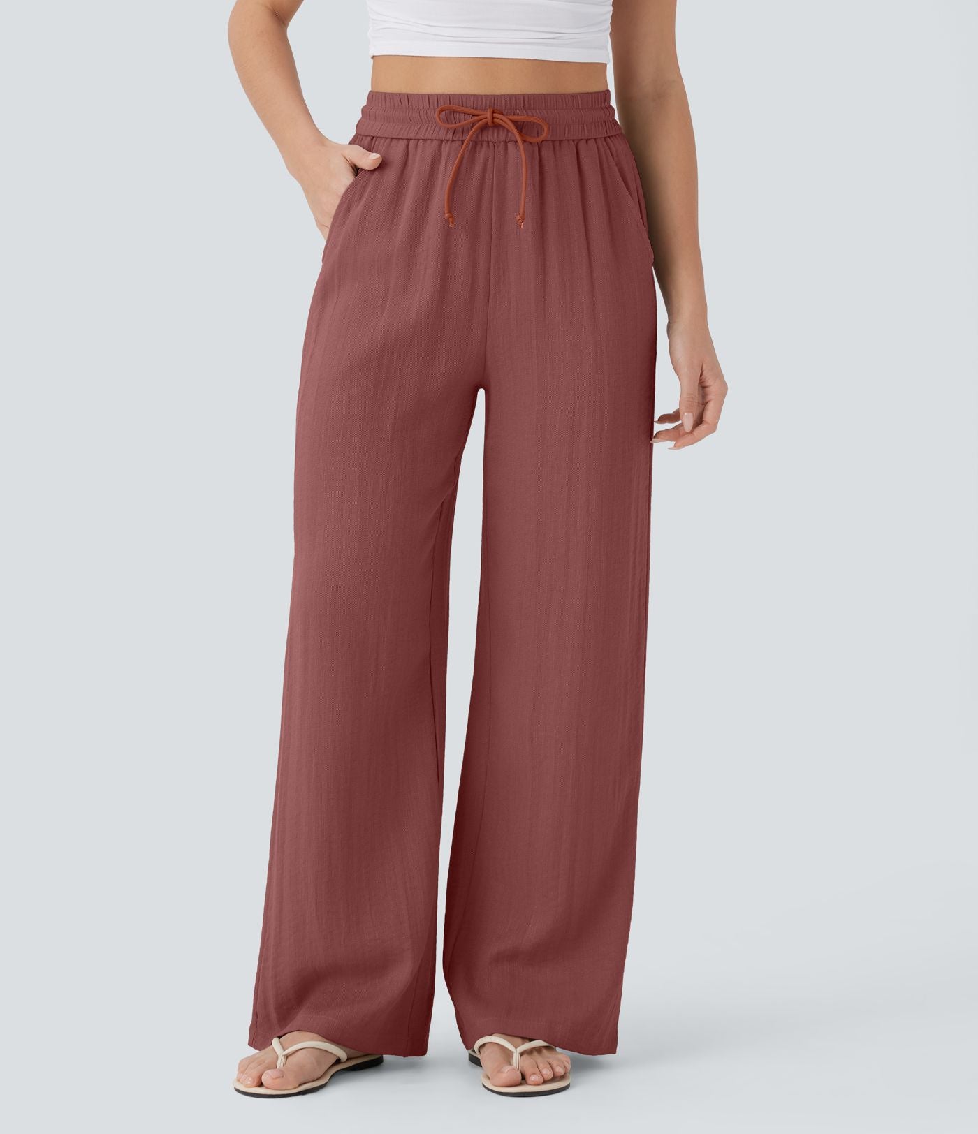 Pantalon large fluide taille haute avec cordon de serrage, poches latérales et aspect lin