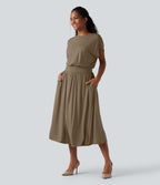 Robe de travail mi-longue fluide gainante à manches chauve-souris avec poches