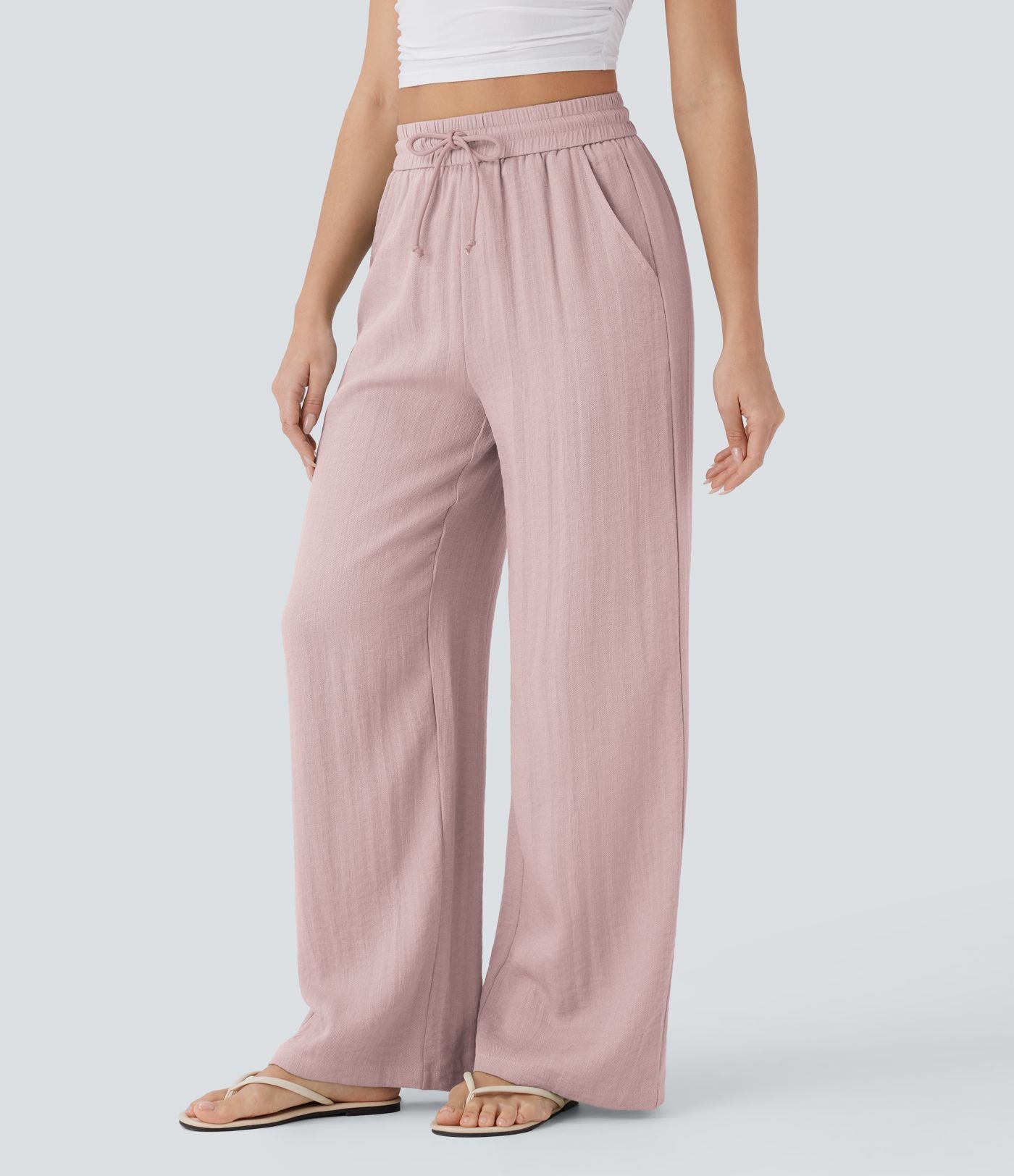 Pantalon large fluide taille haute avec cordon de serrage, poches latérales et aspect lin