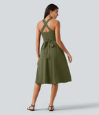 Robe midi fluide sans manches décolleté cœur avec bretelles croisées, nœud dans le dos et poches